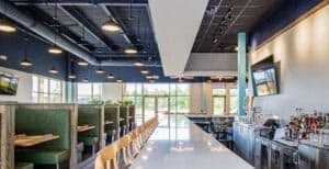Booth seating on the left, bar top seatng on the right
