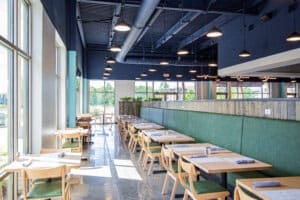Window, 2-person table top seating on the left and bench searing on the right leading to a corner with TV.
